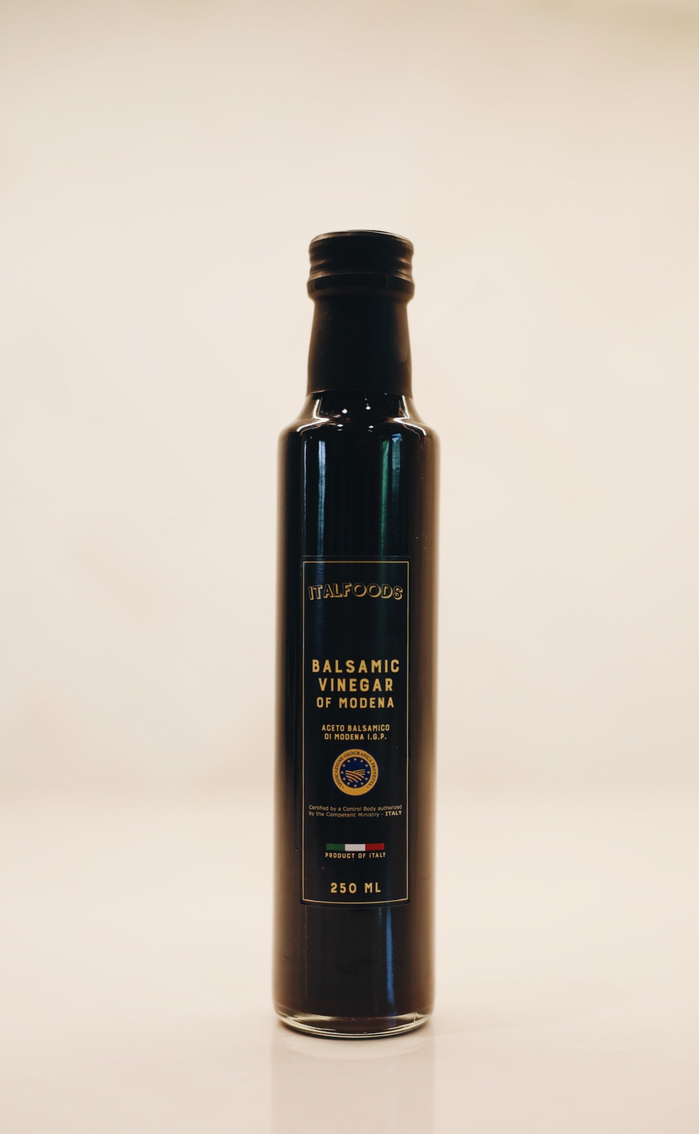 Bottle of balsamic vinegar on a beige background