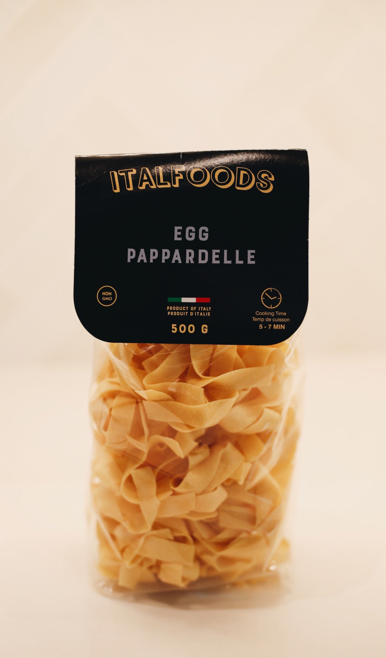 Packaged egg pappardelle pasta from Italfoods on a beige background